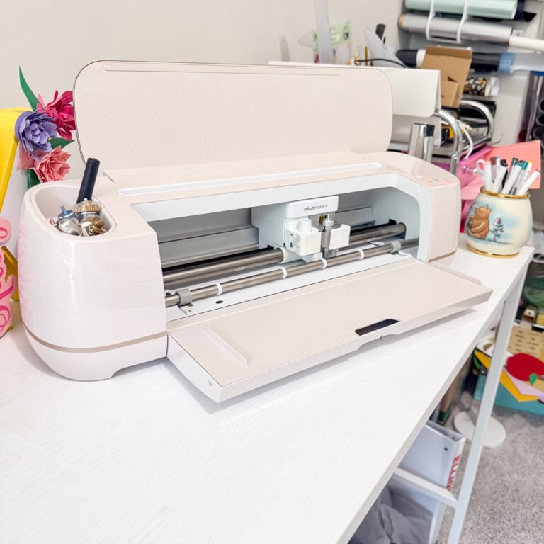 A Cricut Maker 4 in seashell on a white desk.