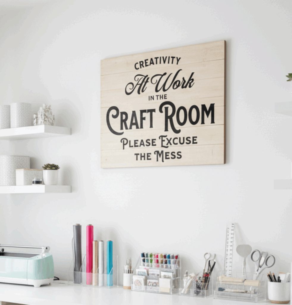 Wood-style craft room wall sign that says creativity at work in the craft room please excuse the mess