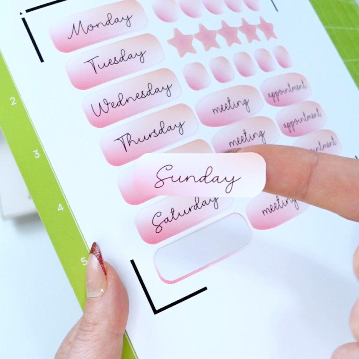 Finished pink planner stickers cut with a Cricut, showing days of the week and appointment labels on printable sticker paper