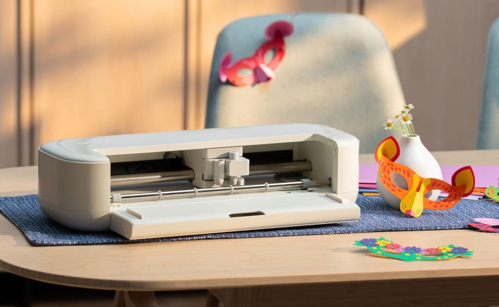 Cricut Explore 5 cutting machine from the new Cricut machines 2026 release shown open on a craft table with paper projects