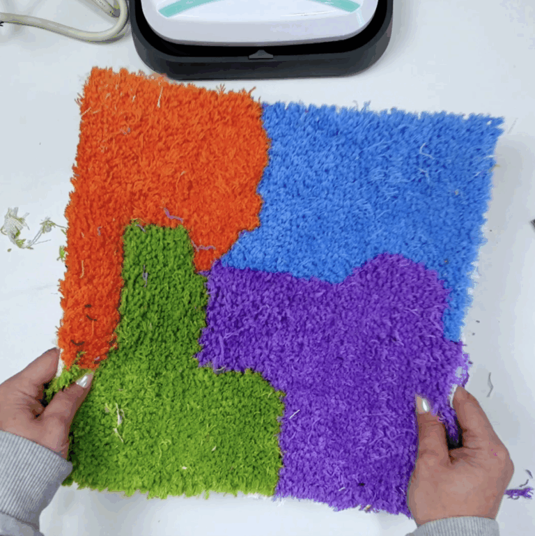 Close up of colorful tufted rug showing soft yarn pile and finished texture.