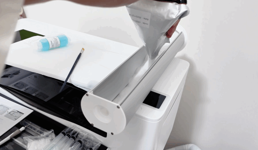 pouring adhesive powder into shaker oven for dtf printing process