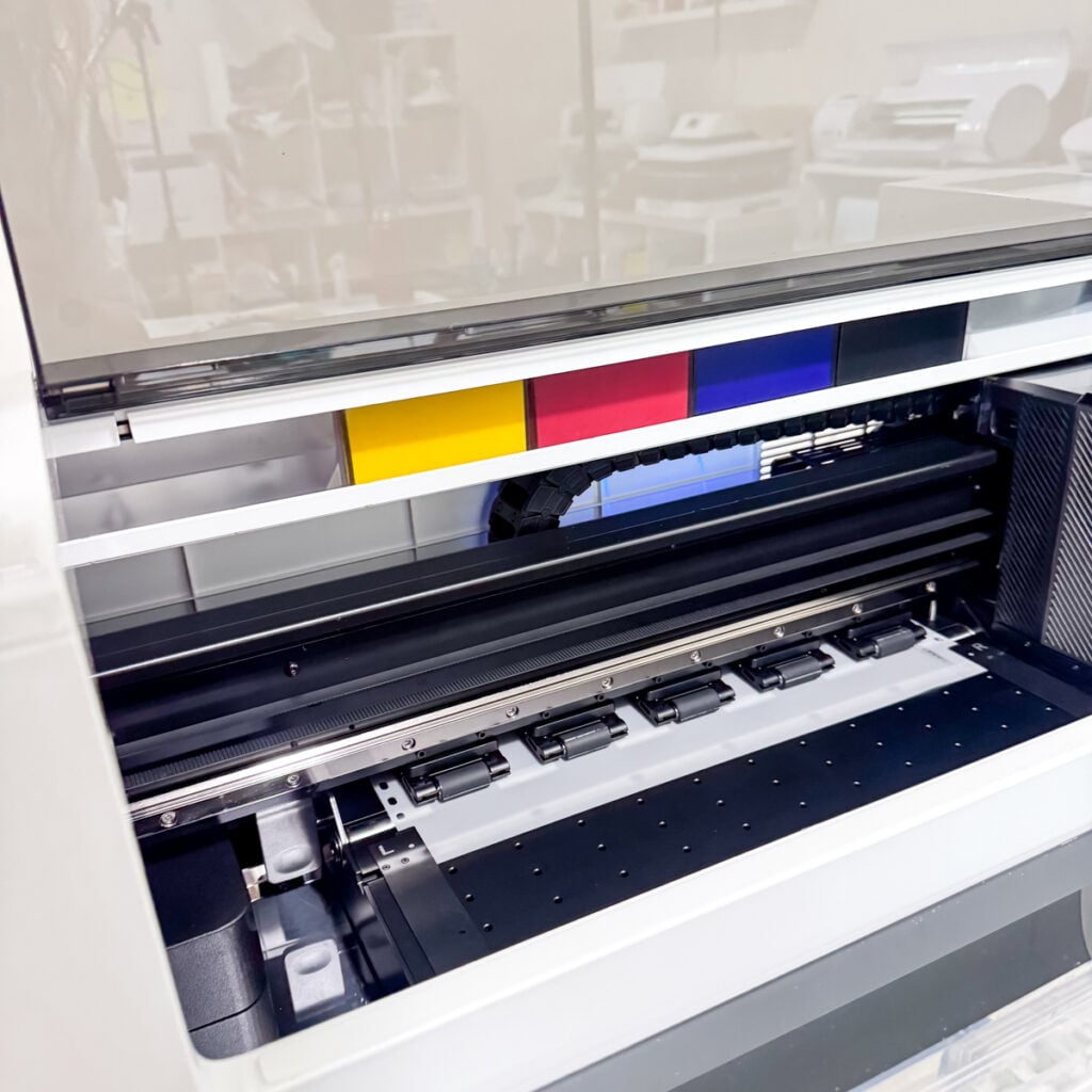 inside xTool apparel printer showing rollers and print bed for dtf transfers.