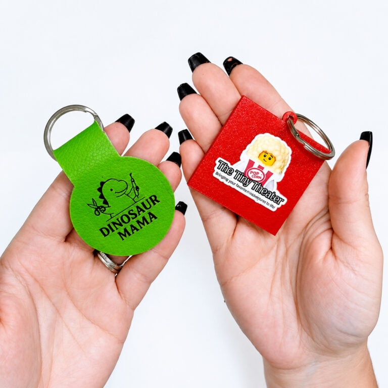 Finished NFC keychains made with Cricut faux leather and a 3D printer for small business marketing.